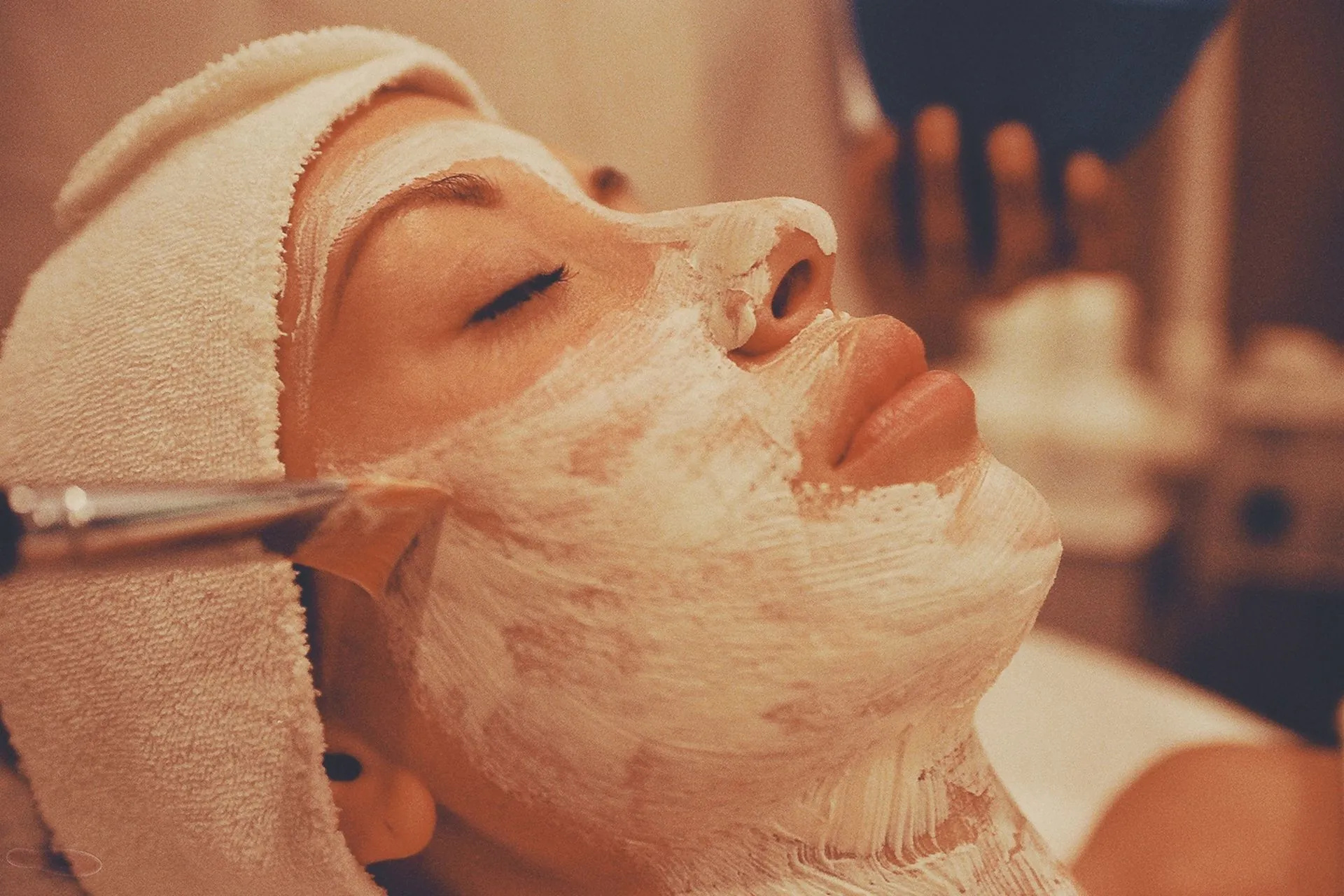 Client relaxing during a facial mask treatment