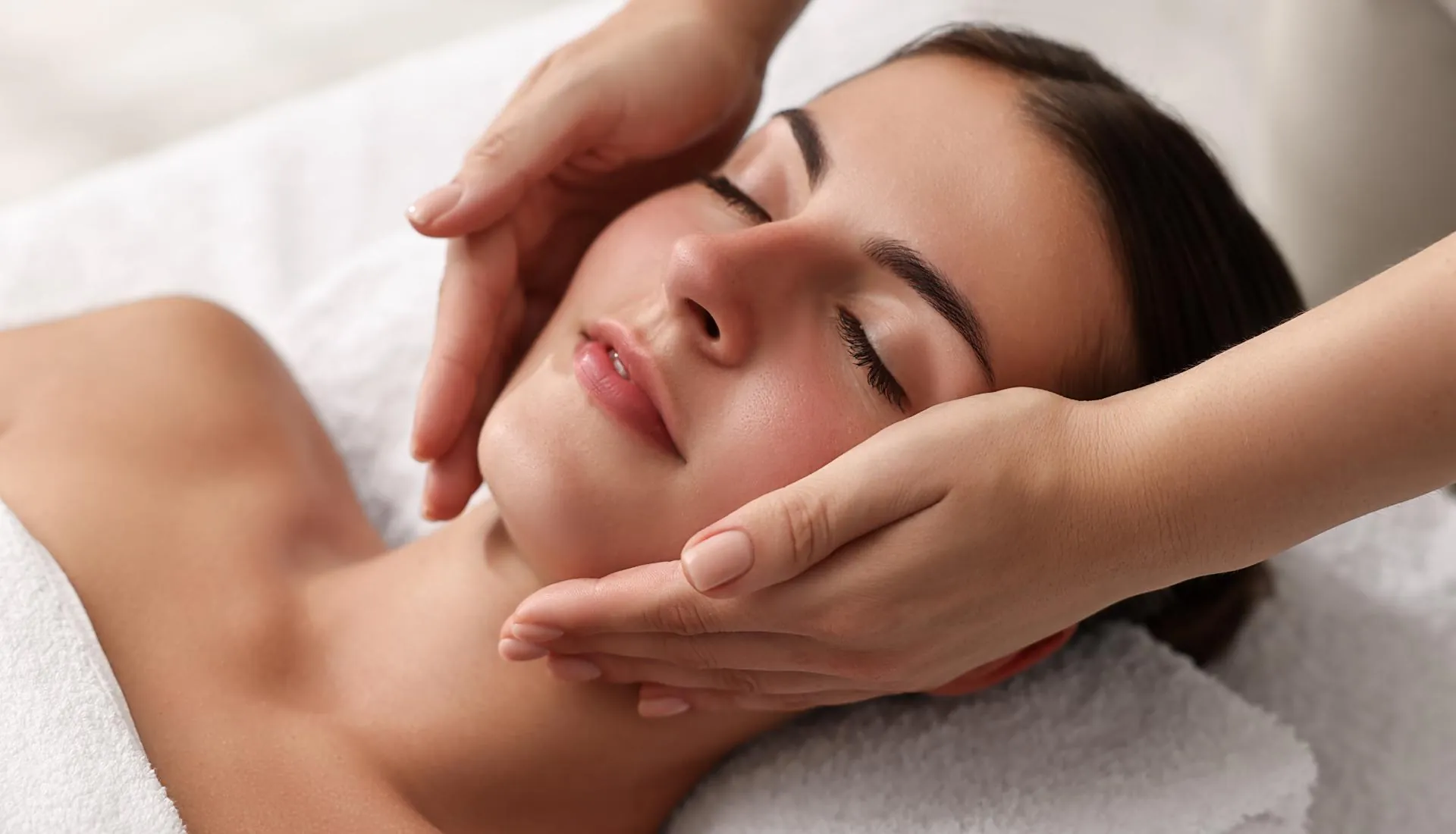 Therapist giving a client a relaxing facial massage